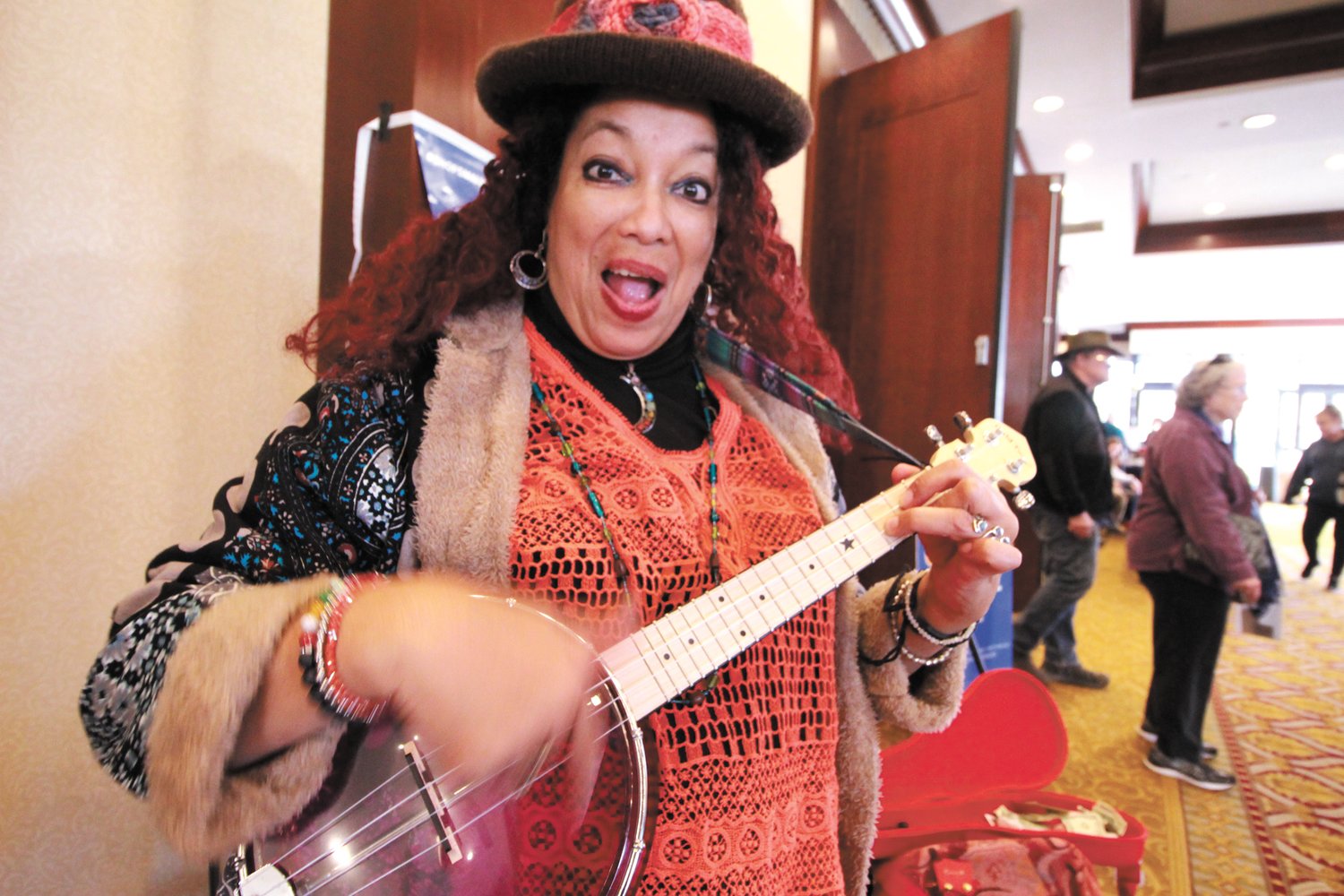 SHARING A TUNE: Doli Grace of Warren brought along her ukulele and her colorful outfit to brighten the day for those attending Small Business Saturday. She said more than the dollars dropped in her instrument case she valued the kids who danced to her music and in particular the boy who pulled the lollipop from his mouth to give it to her. “Just think what that meant to him,” she said.